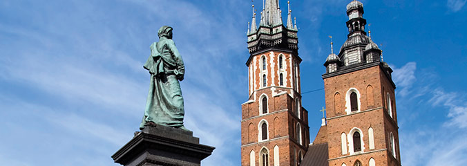 Statue and tall cathedral in Poland