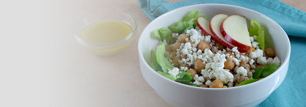 Farrow and apple salad in a white bowl