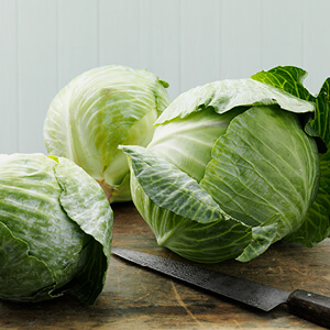 a group of cabbages on a cutting board