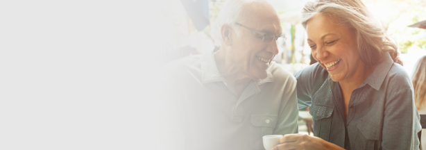 Smiling couple sitting in a cafe drinking coffee together