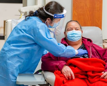 health professional with face mask and shield